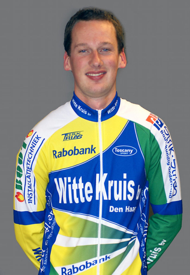 Ein Sportler in Pose mit einem Trikot, auf dem verschiedene Sponsorennamen stehen.