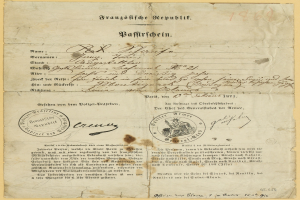 Altes deutsches Regierungsdokument mit einem kreisförmigen schwarzen Stempel auf gelbem Papier, das schwarze Text enthält.