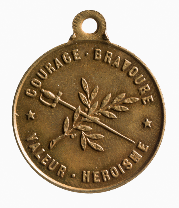 Eine goldene Medaille mit den Worten "Courage, Brave, Valour, Heroism" darauf gegen einen weißen Hintergrund.